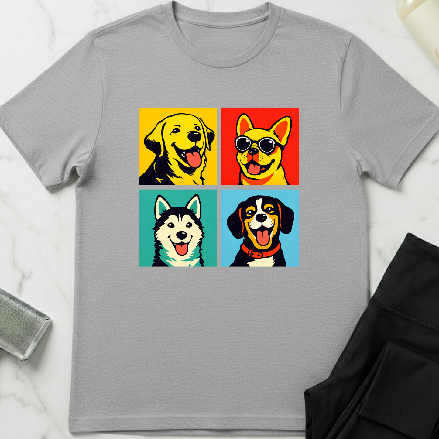 Gray t-shirt with colorful dog illustrations on a white marble surface. Minimalist dog apparel by pemuyo.