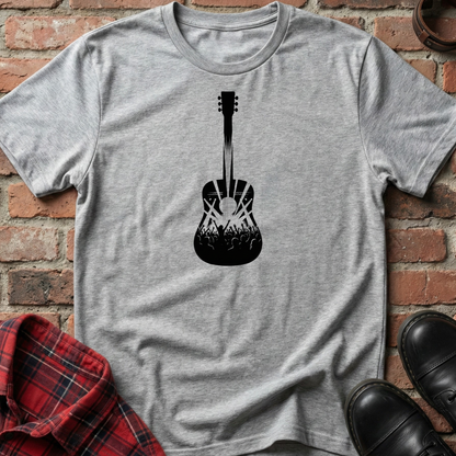 Gray t-shirt with black guitar graphic on a brick background. Minimalist music apparel by pemuyo.