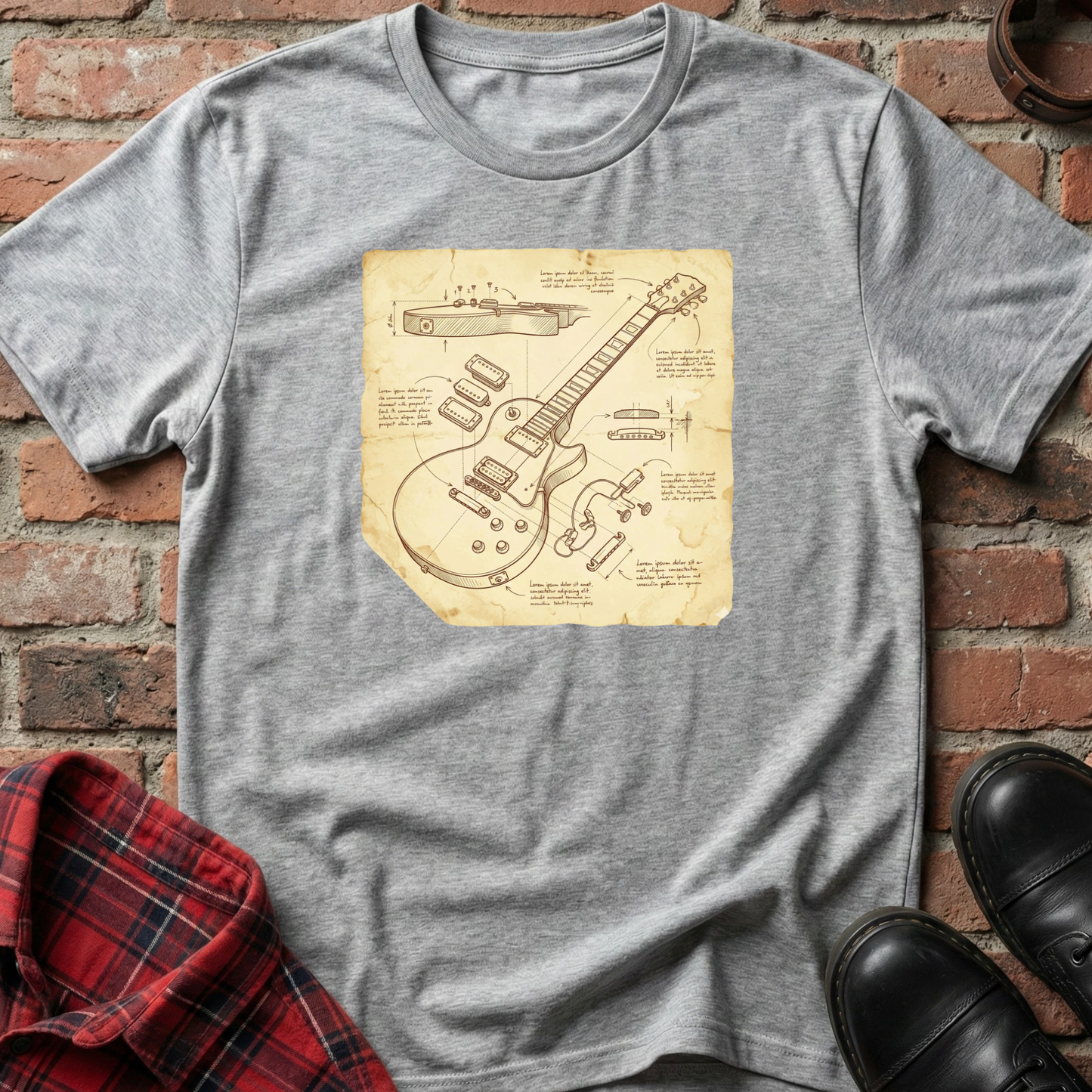 Gray t-shirt with guitar blueprint design on a brick surface. Minimalist music apparel by pemuyo.