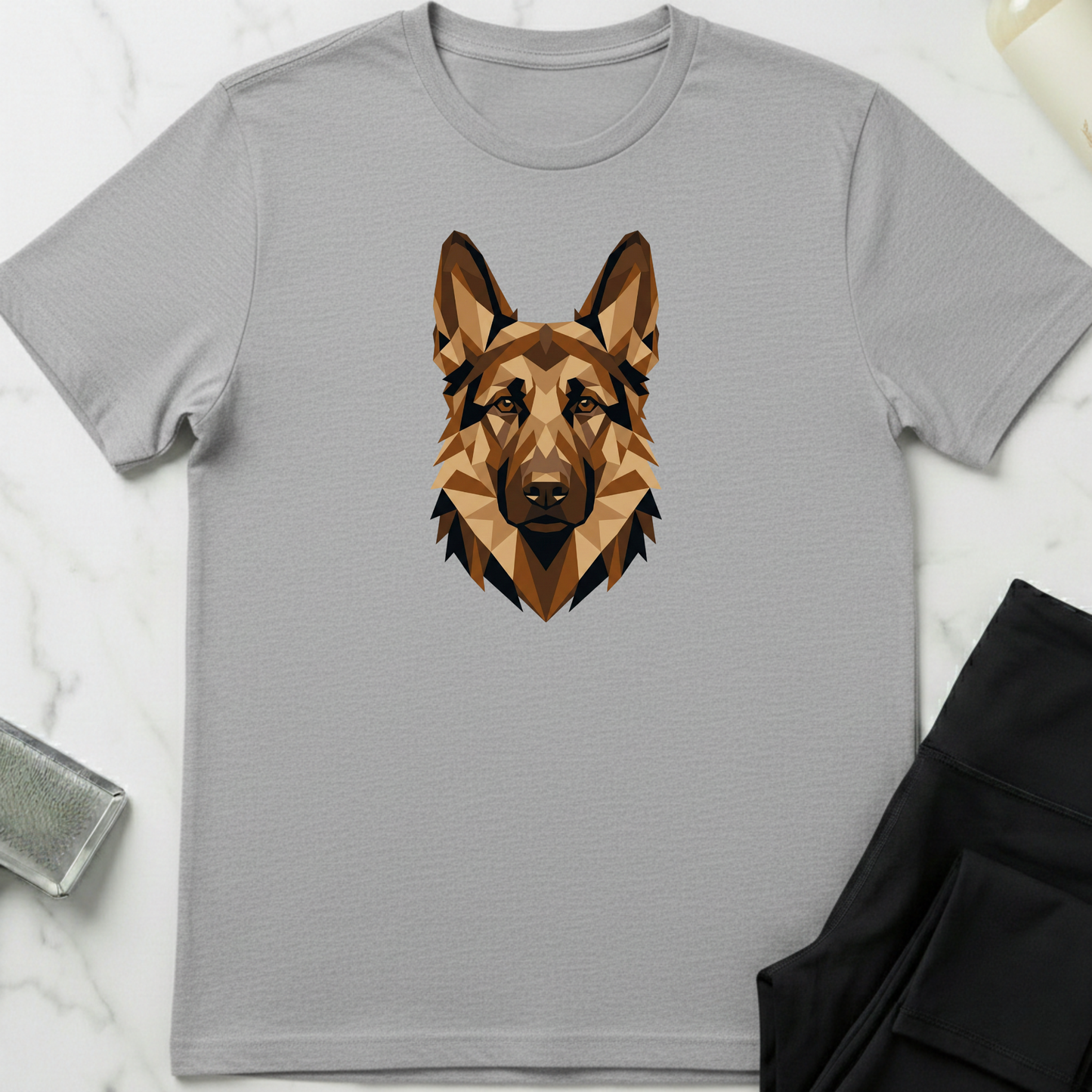 Gray t-shirt with a geometric dog design on a marble surface. Minimalist dog apparel by pemuyo.