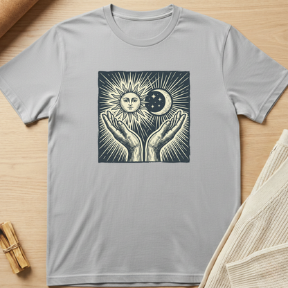 Gray t-shirt with a graphic design of hands holding the sun and moon on a wooden surface. Minimalist yoga apparel by pemuyo.