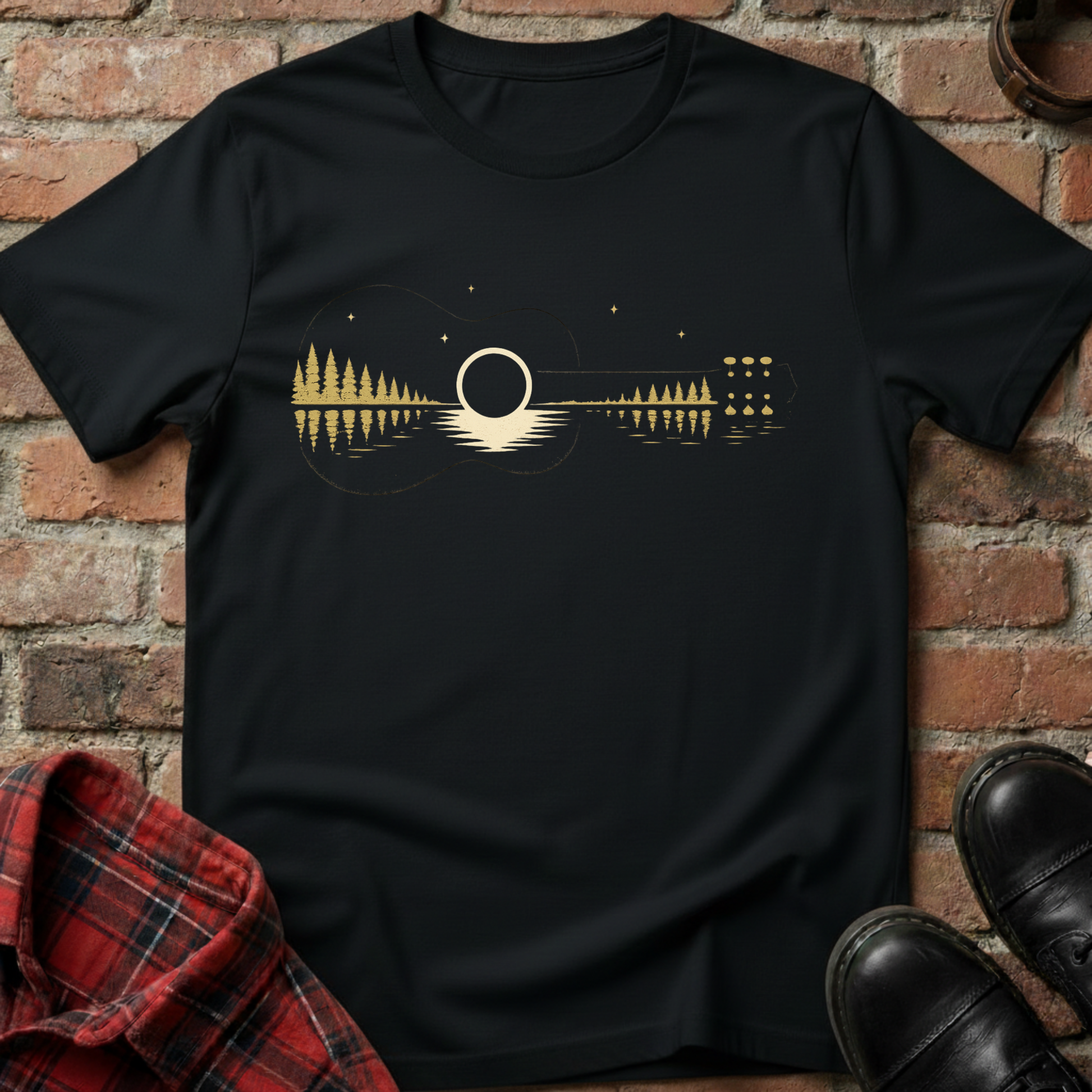 Black t-shirt with a guitar design on a brick background. Minimalist music apparel by pemuyo.