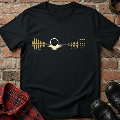 Black t-shirt with a guitar design on a brick background. Minimalist music apparel by pemuyo.