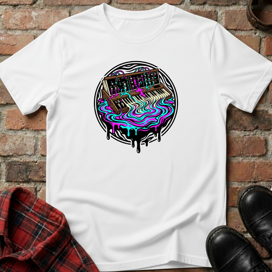 White t-shirt with a colorful graphic design of a keyboard on a brick surface. Minimalist music apparel by pemuyo.