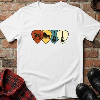 White t-shirt with musical instrument picks design on a brick surface. Minimalist music apparel by pemuyo.