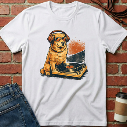 White t-shirt with a dog wearing headphones and sunglasses on a turntable graphic against a brick wall. Minimalist dog apparel by pemuyo.