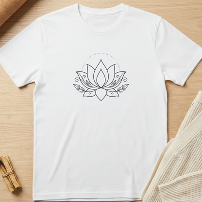 A white short-sleeve crewneck t-shirt with a black line art lotus flower graphic on the chest, displayed flat on a light wood background with neutral props. Minimalist yoga apparel by pemuyo.