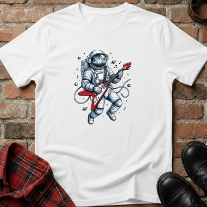 White t-shirt with an astronaut playing a guitar graphic on a brick surface. Minimalist music apparel by pemuyo.
