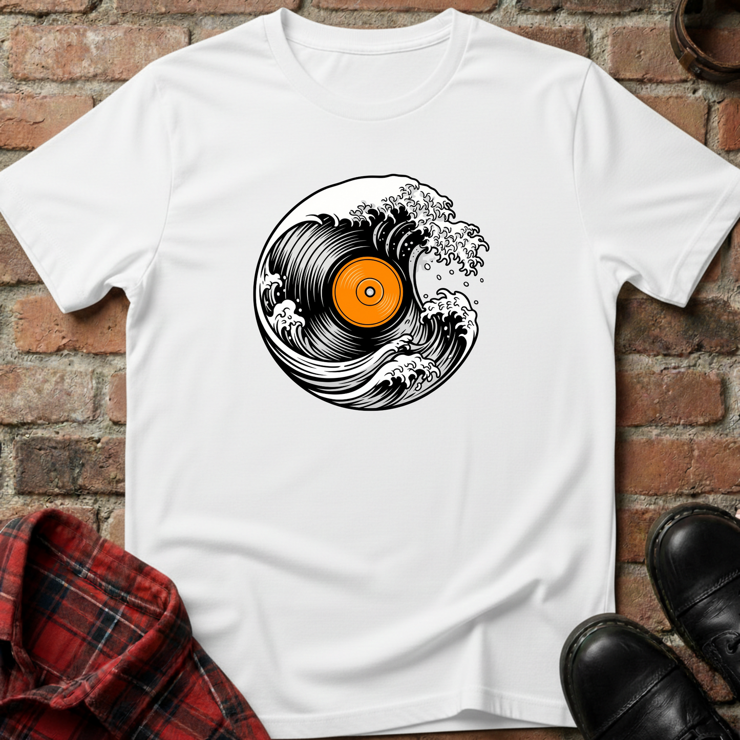 White t-shirt with vinyl record design on a brick surface. Minimalist music apparel by pemuyo.