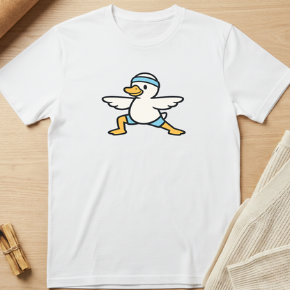 White t-shirt with a cartoon duck design on a wooden surface. Minimalist yoga apparel by pemuyo.