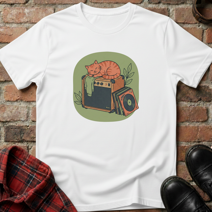 White t-shirt with a graphic of a cat on an amplifier against a brick wall. Minimalist music apparel by pemuyo.