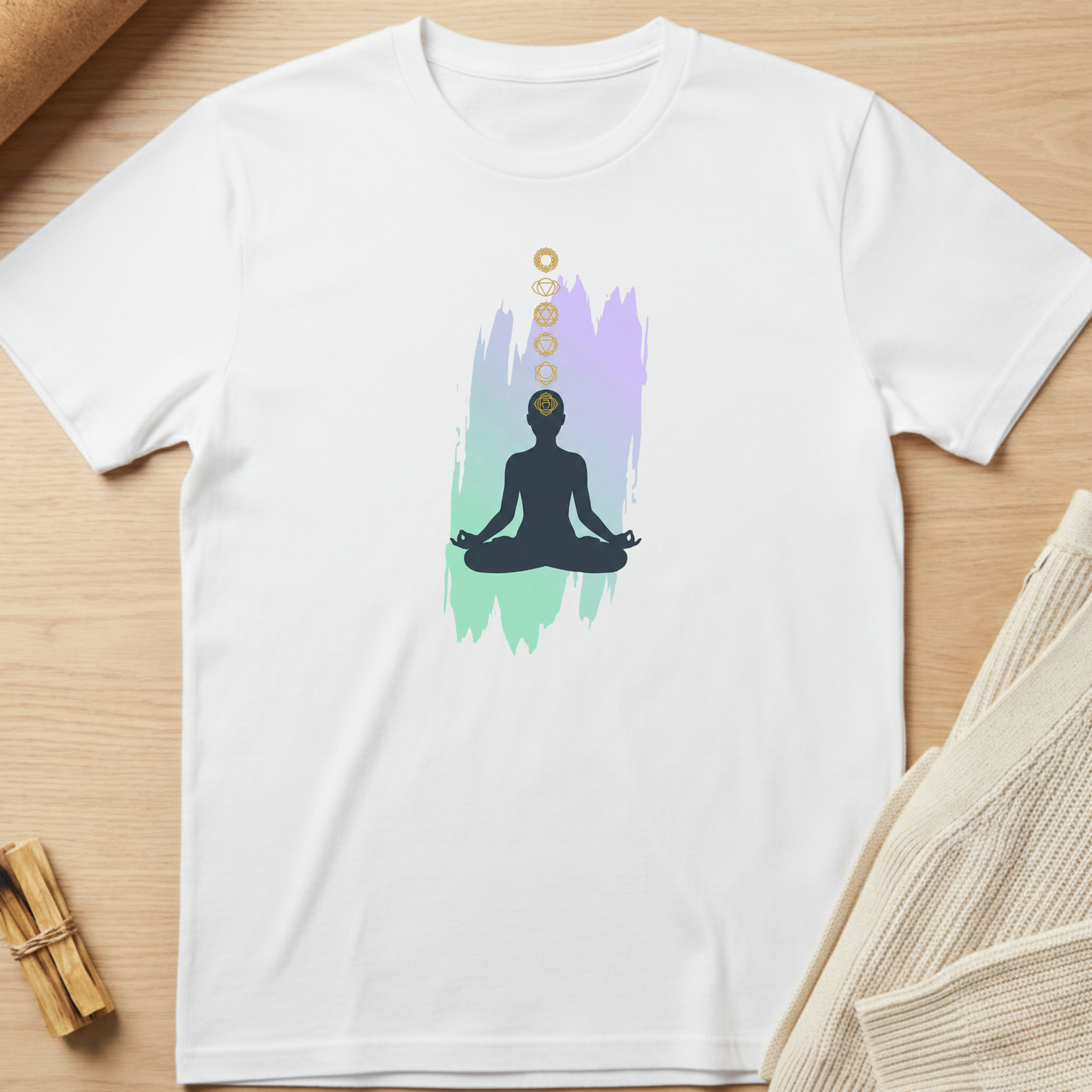 White t-shirt with a meditation graphic on a wooden surface. Minimalist yoga apparel by pemuyo.