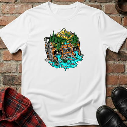 White t-shirt with a graphic design of a vintage radio in a forest, placed on a brick surface. Minimalist music apparel by pemuyo.