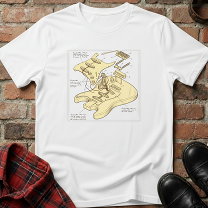 White t-shirt with guitar diagram design on a brick surface. Minimalist music apparel by pemuyo.