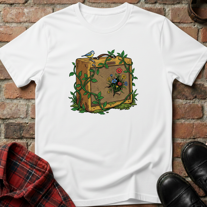 White t-shirt with a suitcase and floral design on a brick surface. Minimalist music apparel by pemuyo.