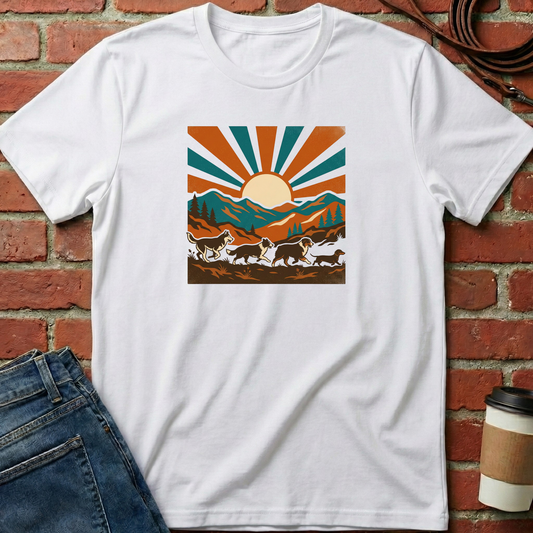 White t-shirt with a mountain and sun design on a brick wall background. Minimalist dog apparel by pemuyo.