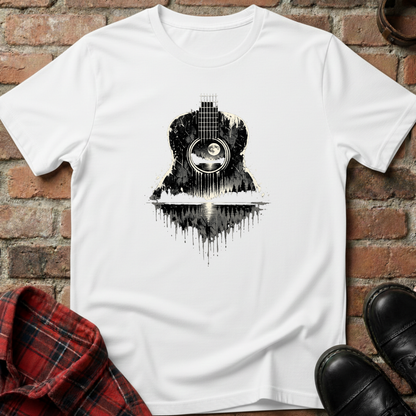 White t-shirt with black and white guitar design on a brick wall background. Minimalist music apparel by pemuyo.