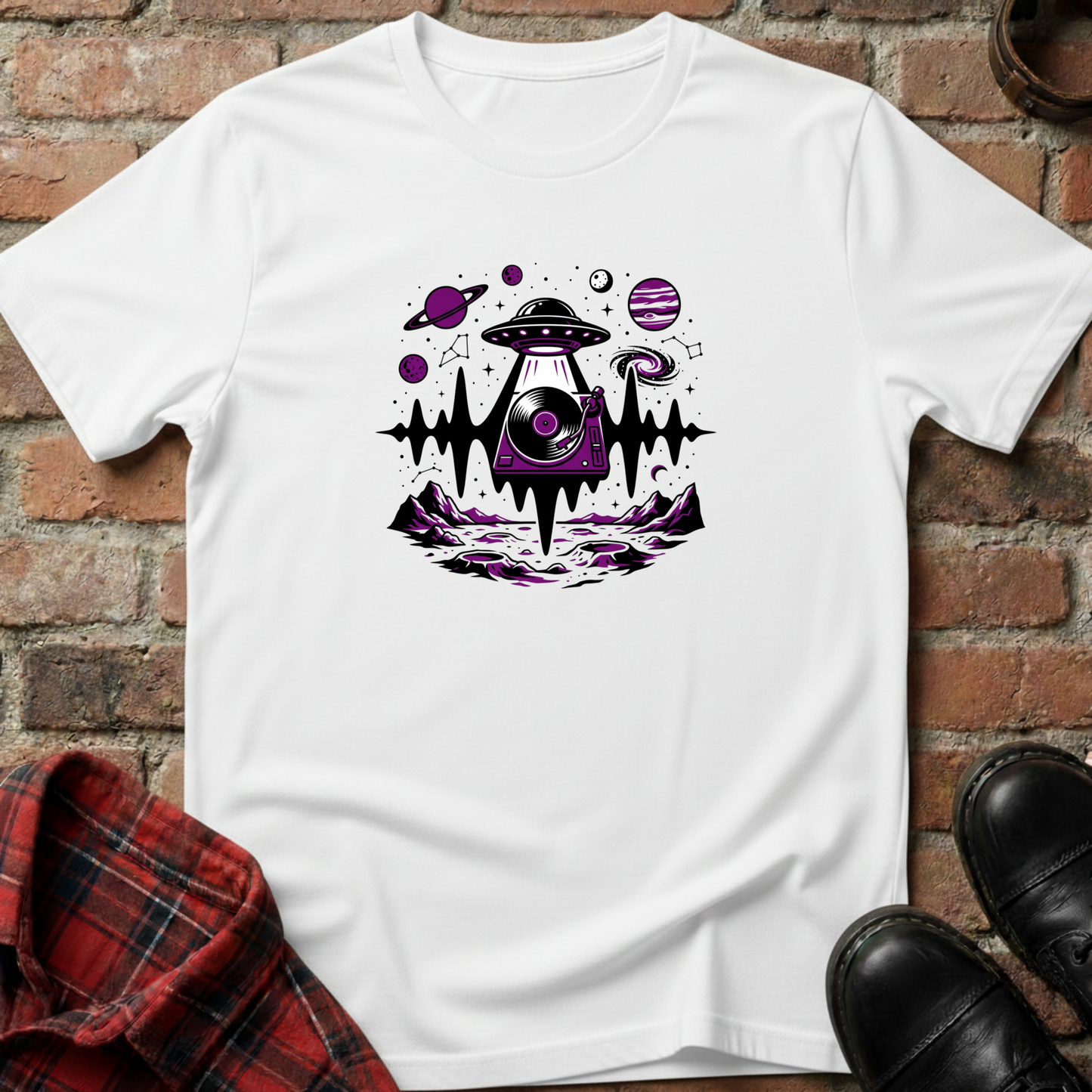 White t-shirt with alien UFO design on a brick surface. Minimalist music apparel by pemuyo.