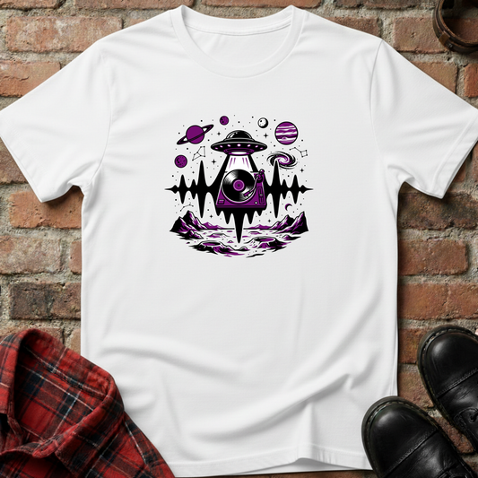 White t-shirt with alien UFO design on a brick surface. Minimalist music apparel by pemuyo.