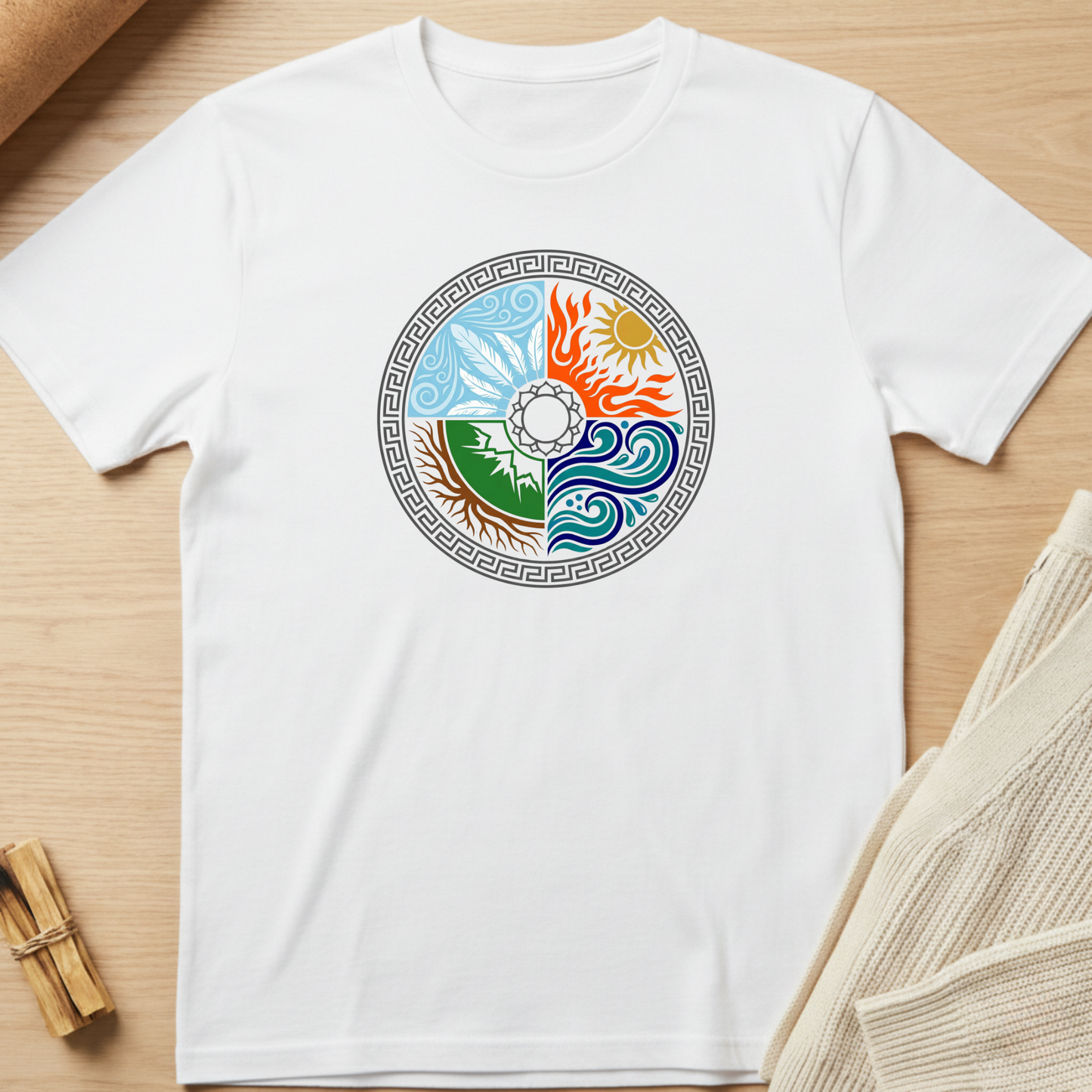 White t-shirt with a colorful circular design on a wooden surface. Minimalist yoga apparel by pemuyo.