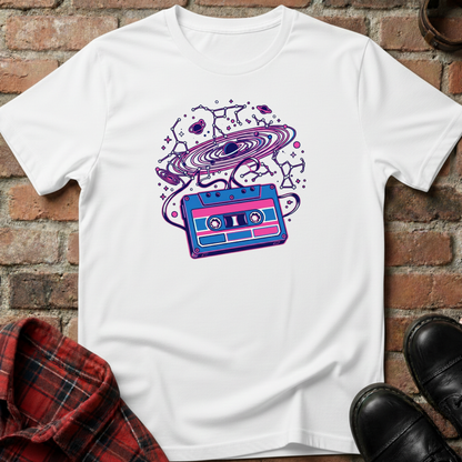 White t-shirt with a colorful cassette tape graphic on a brick surface. Minimalist music apparel by pemuyo.