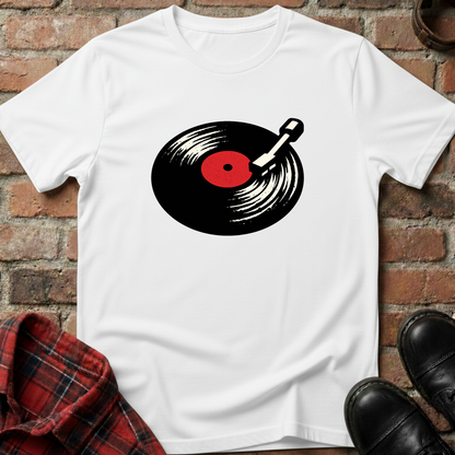 White t-shirt with a vinyl record graphic on a brick surface. Minimalist music apparel by pemuyo.