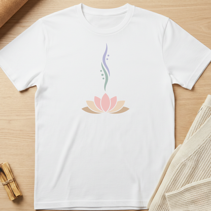 White t-shirt with a pink lotus flower design on a wooden surface. Minimalist yoga apparel by pemuyo.