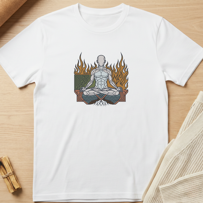 A white short-sleeve crewneck t-shirt laid flat on a light wood surface, featuring a central graphic of a meditating figure surrounded by flames and a green geometric emblem. Minimalist yoga apparel by pemuyo.