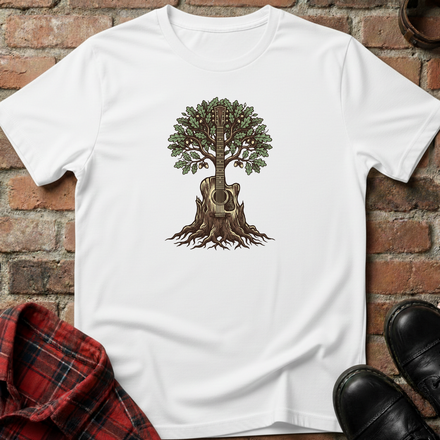 White t-shirt with a tree and guitar design on a brick surface. Minimalist music apparel by pemuyo.