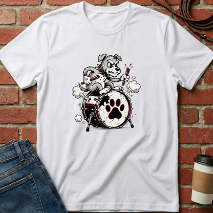White t-shirt with a dog playing drums graphic on a brick wall background. Minimalist dog apparel by pemuyo.