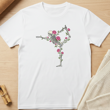 White t-shirt with a skeleton and floral design on a wooden surface. Minimalist yoga apparel by pemuyo.