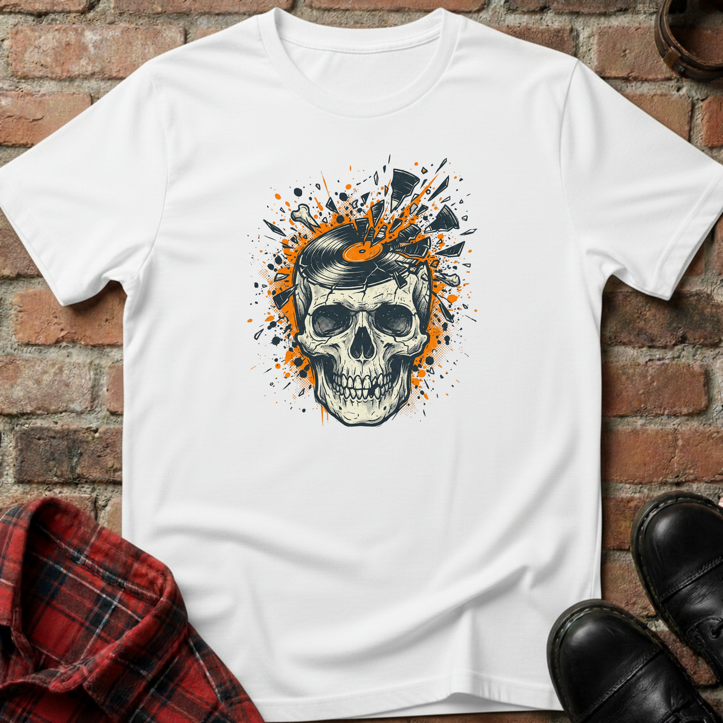 White t-shirt with a skull design on a brick surface. Minimalist music apparel by pemuyo.