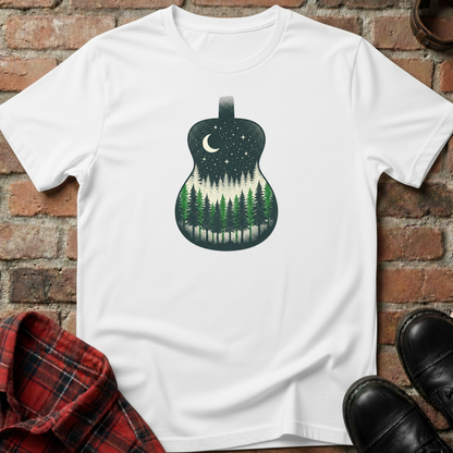 White t-shirt with guitar and forest design on a brick surface. Minimalist music apparel by pemuyo.