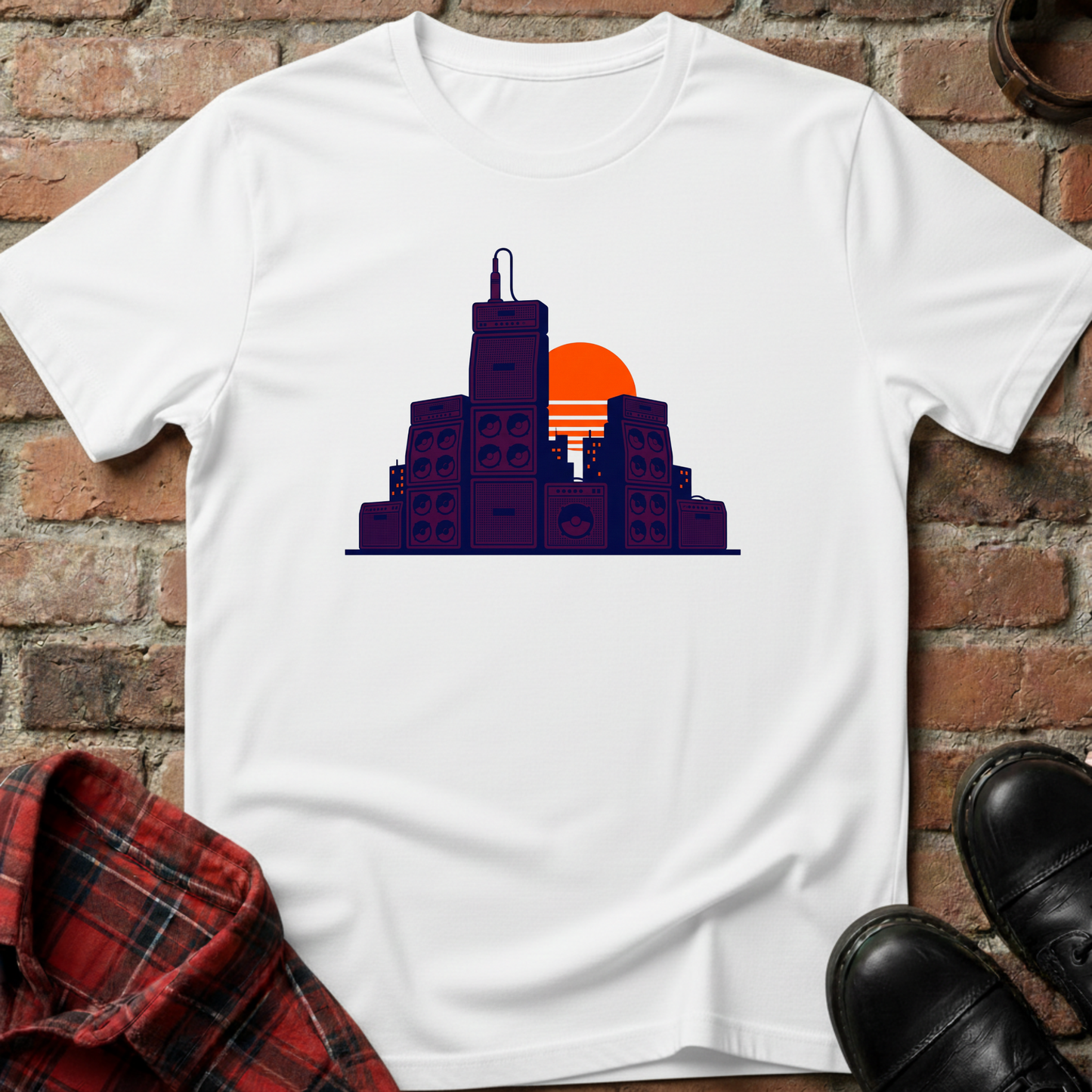 White t-shirt with cityscape design on a brick wall background. Minimalist music apparel by pemuyo.