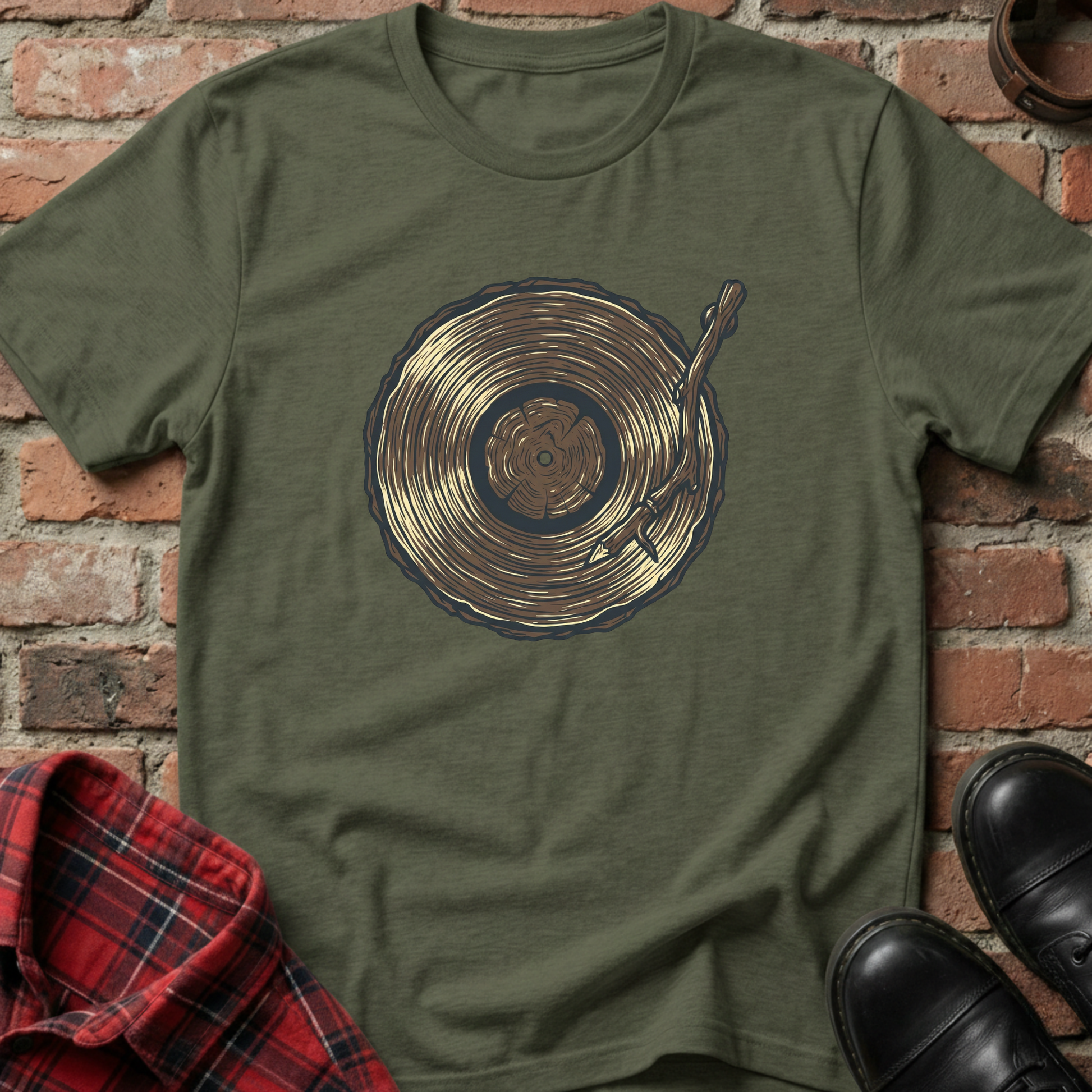 Green t-shirt with vinyl record design on a brick wall background. Minimalist music apparel by pemuyo.