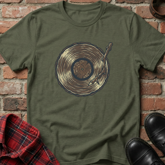 Green t-shirt with vinyl record design on a brick wall background. Minimalist music apparel by pemuyo.